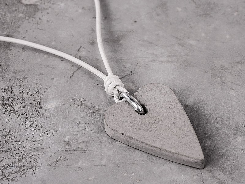 Heart-shaped pendant on a white leather strap