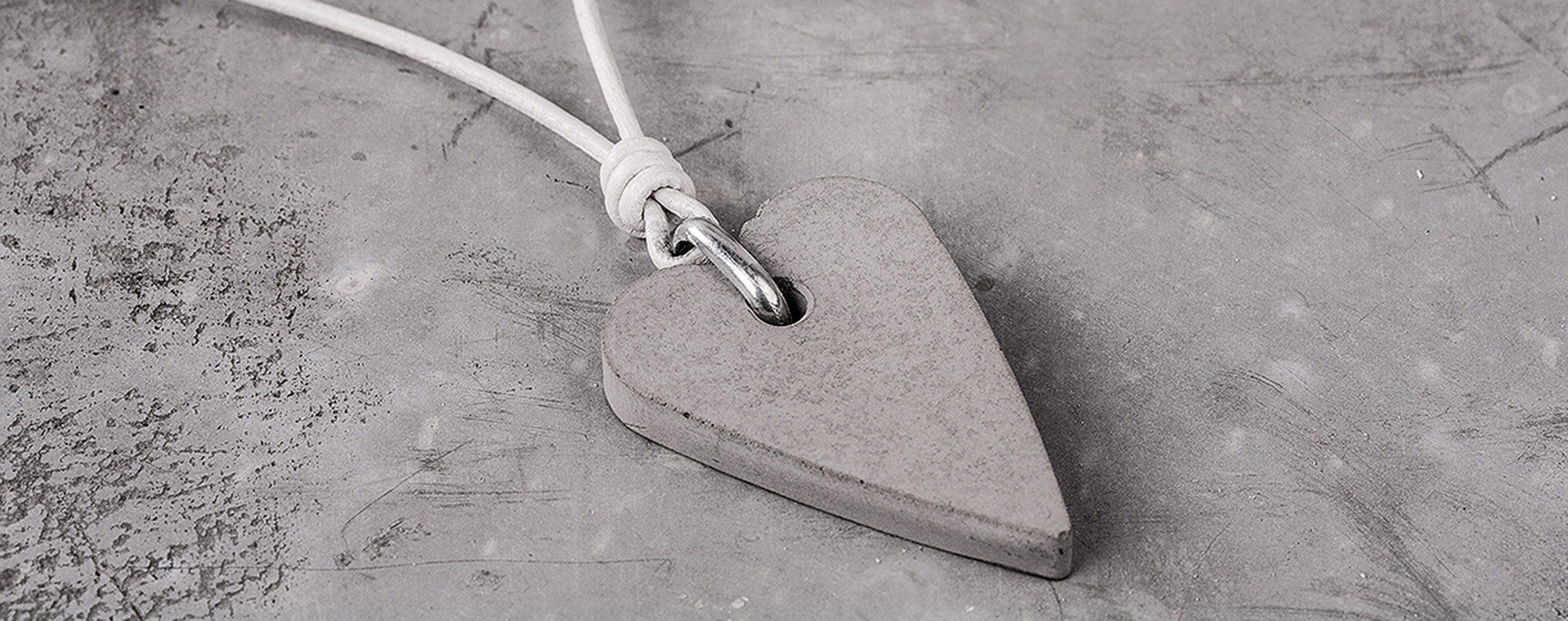 Heart-shaped pendant on a white leather strap