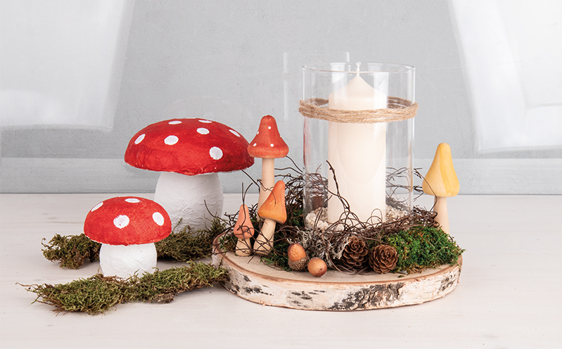 Pilze mit Kerzenglas auf Holz