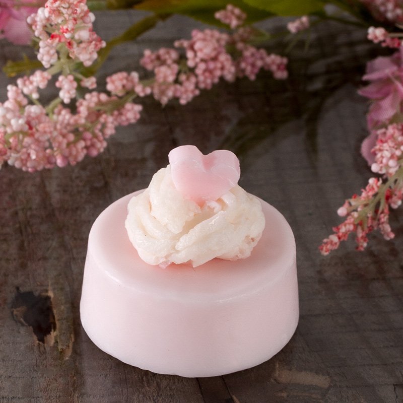 Round light-pink soap with cream rosette
